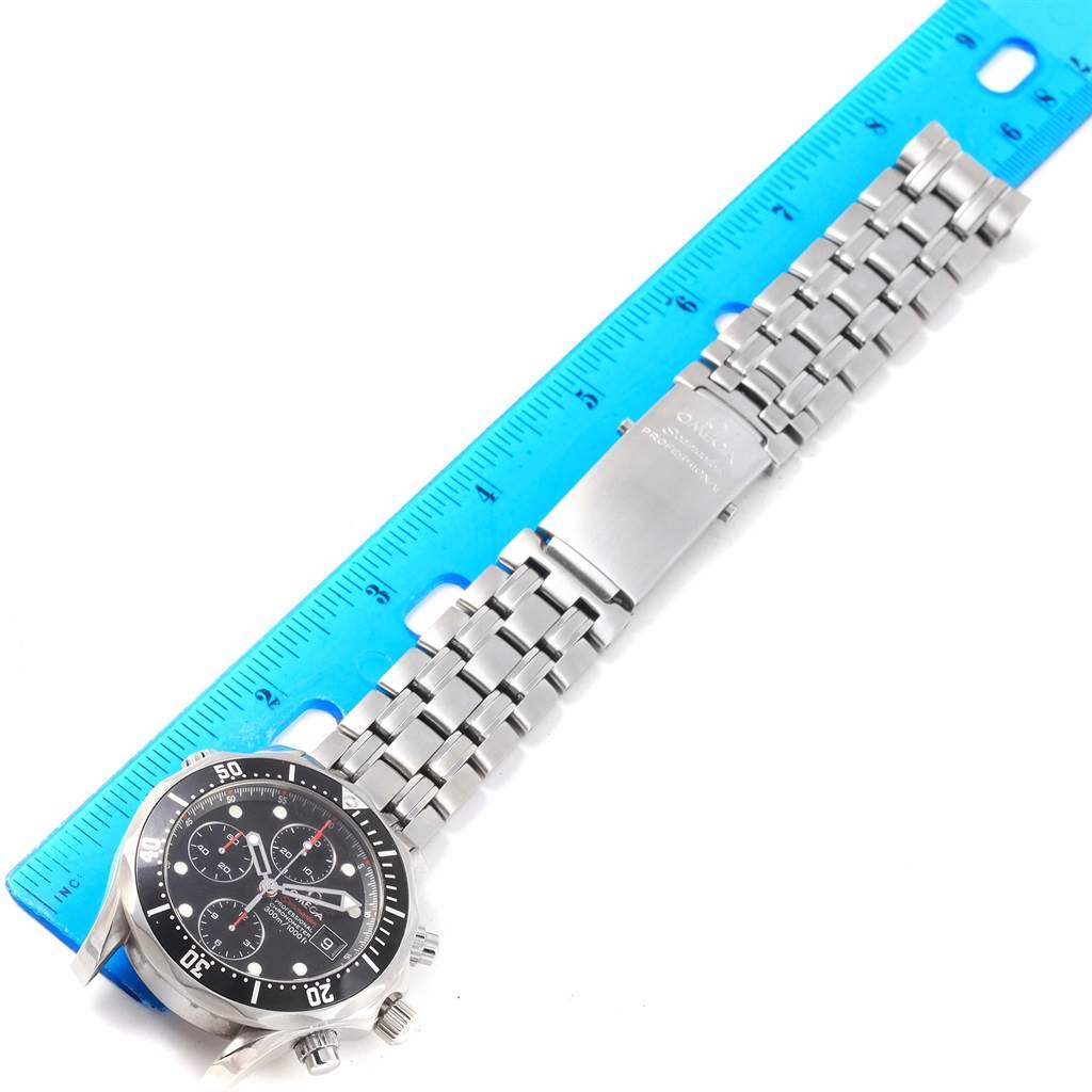 The Omega Seamaster 213.30.42.40.01.001 Men
s Stainless Steel Black Dial 213.30.42.40.01.001 Men
s Stainless Steel Black Dial watch is shown from a top-down angle, highlighting the face, bezel, and stainless steel bracelet alongside a ruler.