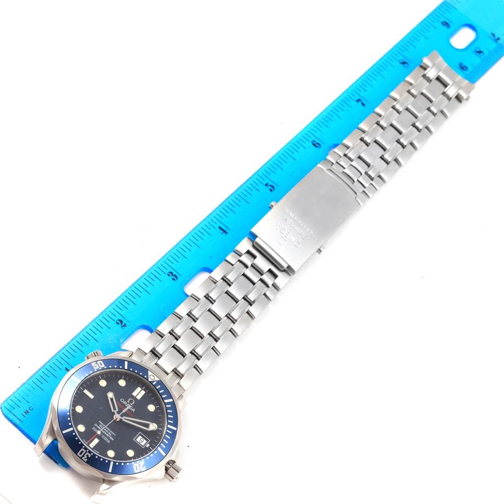 The image shows an Omega Seamaster 2220.80.00 Men
s Stainless Steel Blue Dial 2220.80.00 Men
s Stainless Steel Blue Dial watch laid flat alongside a ruler, displaying the face and metal bracelet.