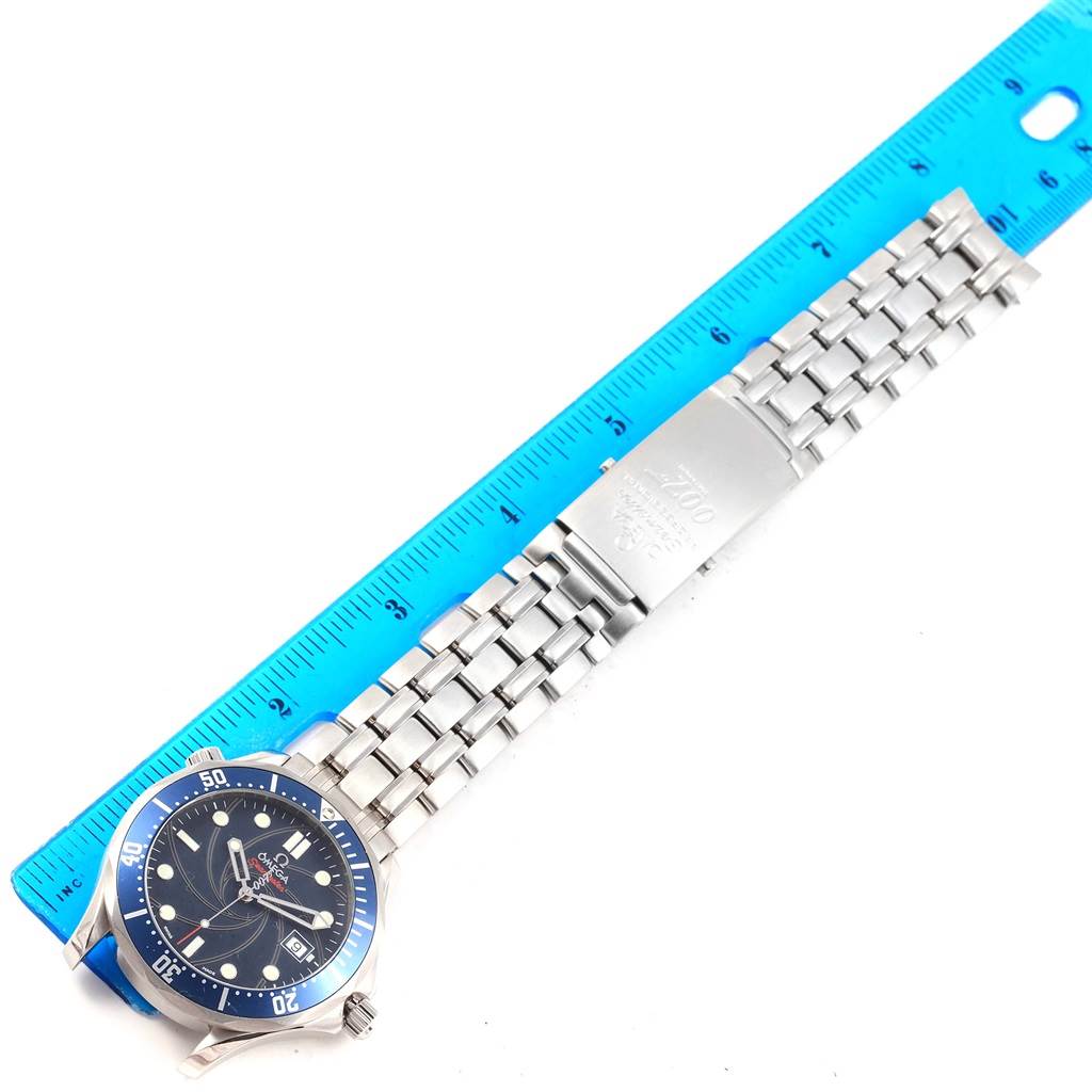 The image shows the front view of an Omega Seamaster 2226.80.00 Men's Stainless Steel Blue Dial 2226.80.00 Men's Stainless Steel Blue Dial watch measuring its stainless steel bracelet with a ruler.