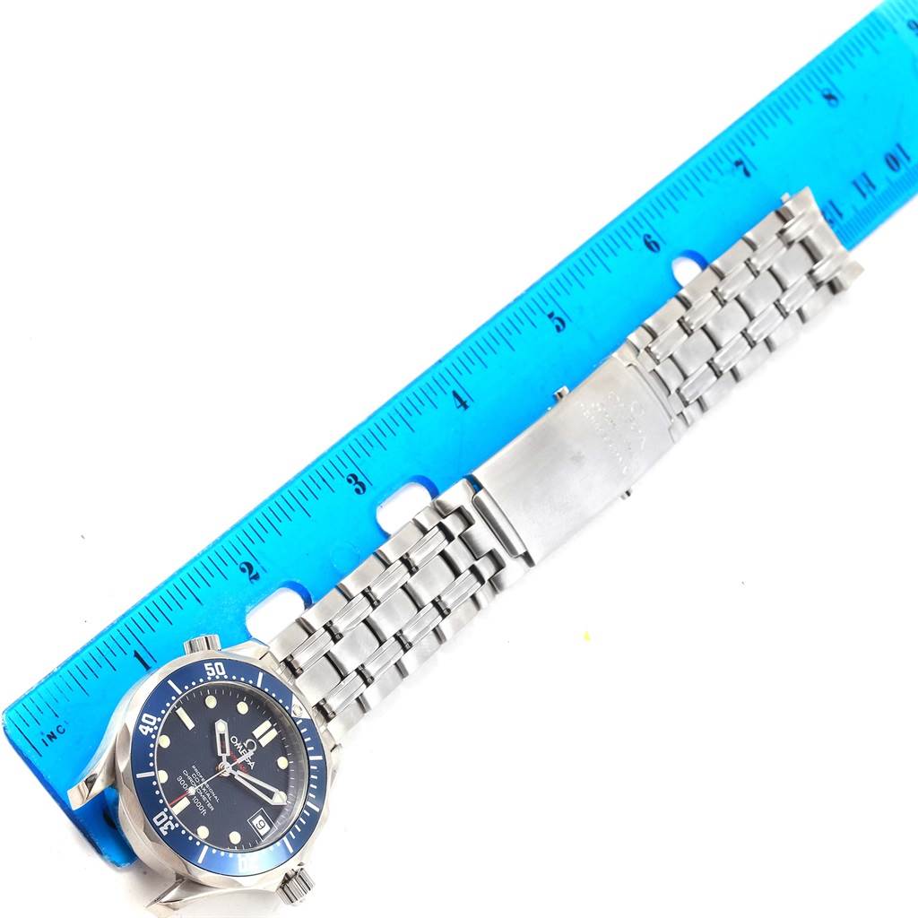 The image shows an Omega Seamaster 2222.80.00 Men
s Stainless Steel Blue Dial 2222.80.00 Men
s Stainless Steel Blue Dial watch laying flat next to a blue ruler, showcasing the full bracelet and the watch face.