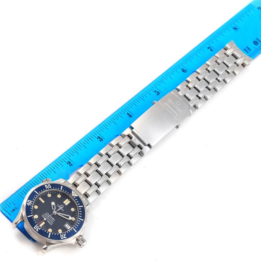 The image shows an Omega Seamaster 2551.80.00 Men's Stainless Steel Blue Dial 2551.80.00 Men's Stainless Steel Blue Dial watch with a stainless steel bracelet, laid flat next to a ruler.