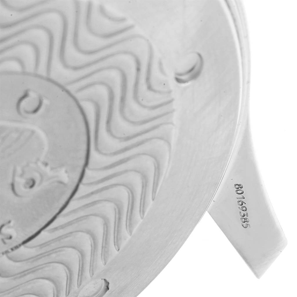 The image shows a close-up of the case back of an Omega Seamaster 2531.80.00 Men
s Stainless Steel Blue Dial 2531.80.00 Men
s Stainless Steel Blue Dial watch, featuring engravings and part of the unique wave pattern.