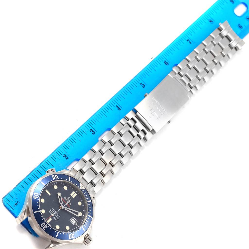 The image shows the face and bracelet of an Omega Seamaster 2220.80.00 Men's Stainless Steel Blue Dial 2220.80.00 Men's Stainless Steel Blue Dial watch, lying against a ruler for size reference.