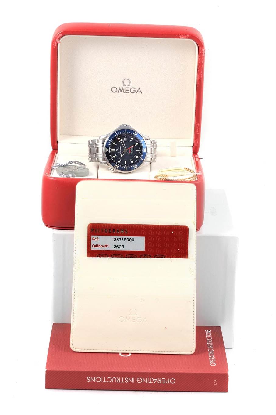 The Omega Seamaster 2535.80.00 Men
s Stainless Steel Blue Dial 2535.80.00 Men
s Stainless Steel Blue Dial watch is shown front-on inside its open box, along with paperwork and identification cards.