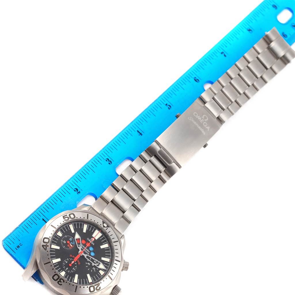 The image shows the Omega Seamaster 2269.52.00 Men's Titanium Black Dial 2269.52.00 Men's Titanium Black Dial watch laid flat next to a blue ruler, displaying its face and metal band clasp.