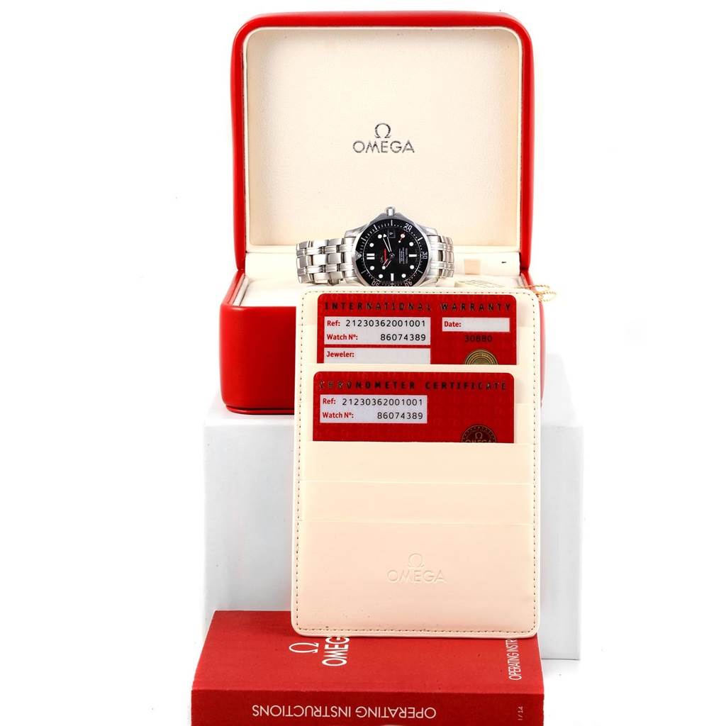 The image shows an Omega Seamaster 212.30.36.20.01.001 Men
s Stainless Steel Black Dial 212.30.36.20.01.001 Men
s Stainless Steel Black Dial watch from a front angle, along with its open case, warranty cards, and instruction manual.
