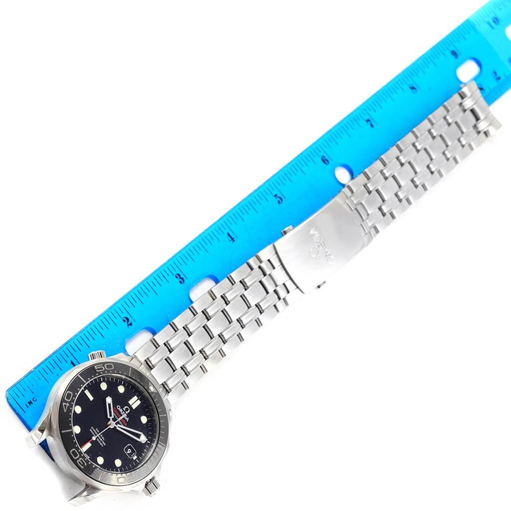 The image shows an Omega Seamaster 212.30.41.20.01.003 Men
s Stainless Steel Black Dial 212.30.41.20.01.003 Men
s Stainless Steel Black Dial watch laid flat with a metal bracelet next to a blue ruler.