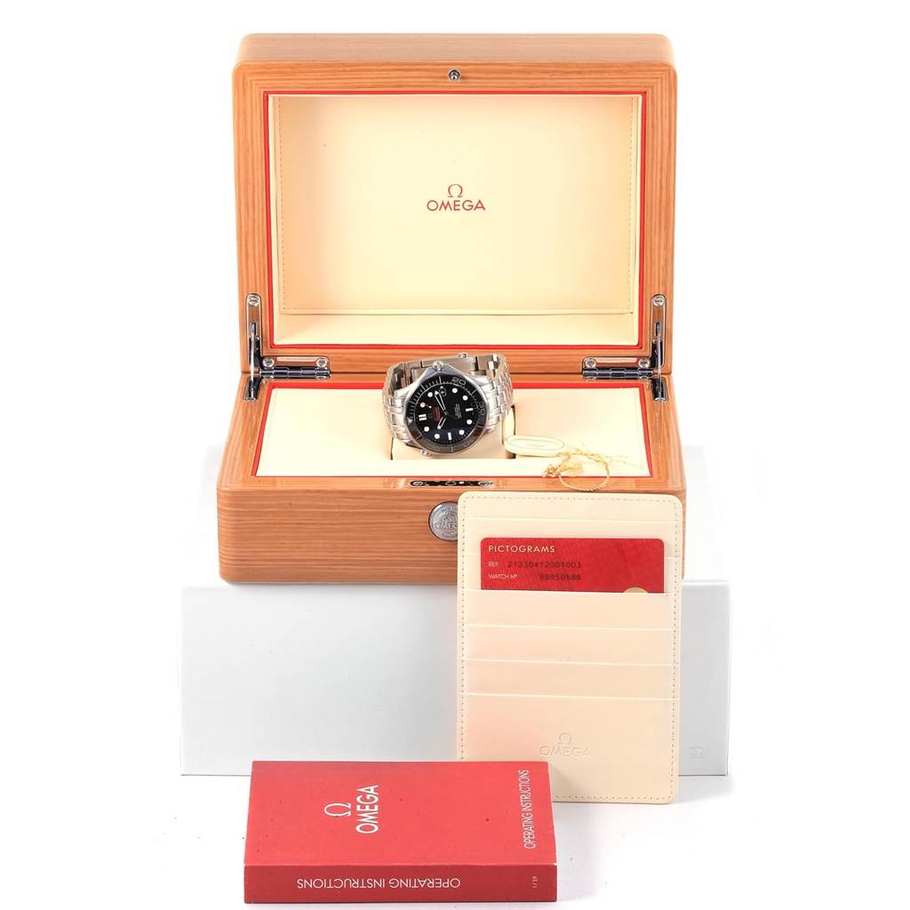 The image shows an Omega Seamaster 212.30.41.20.01.003 Men
s Stainless Steel Black Dial 212.30.41.20.01.003 Men
s Stainless Steel Black Dial watch in its box, along with a booklet and a cardholder containing a red card.