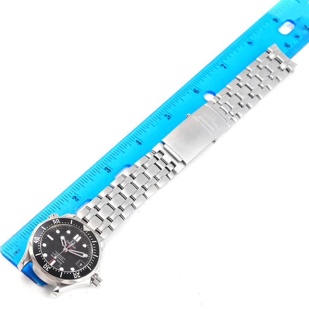 The image shows a top-down view of the Omega Seamaster 212.30.36.20.01.001 Men
s Stainless Steel Black Dial 212.30.36.20.01.001 Men
s Stainless Steel Black Dial watch, featuring the face, bracelet, clasp, and a blue ruler for scale.