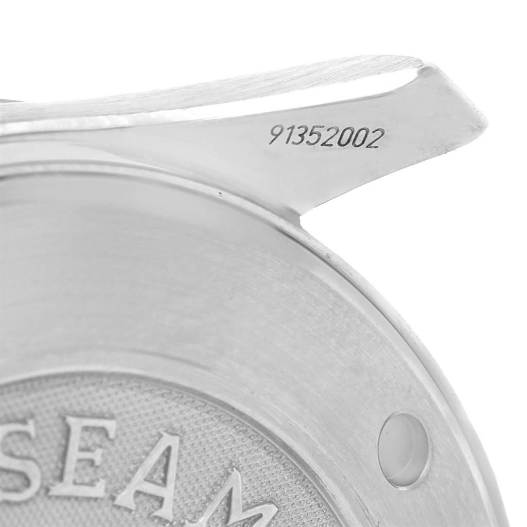 Close-up of an Omega Seamaster 212.30.41.61.01.001 Men
s Stainless Steel Black Dial 212.30.41.61.01.001 Men
s Stainless Steel Black Dial watch, showing the serial number and part of the engraved back case with the "SEAM" logo.