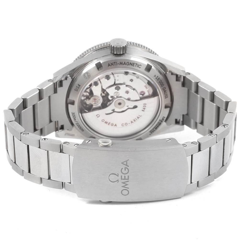 The image shows the back view of an Omega Seamaster 233.90.41.21.03.001 Men's Titanium Blue Dial 233.90.41.21.03.001 Men's Titanium Blue Dial watch, highlighting the transparent case back and bracelet clasp.