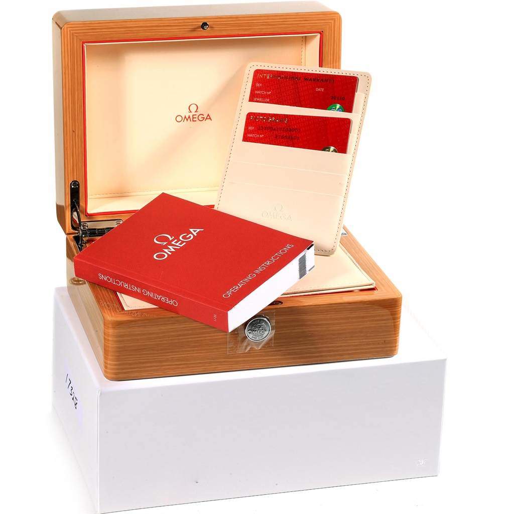 The image shows the packaging for an Omega Seamaster 233.90.41.21.03.001 Men's Titanium Blue Dial 233.90.41.21.03.001 Men's Titanium Blue Dial, including the wooden box, operating instructions manual, and warranty cards.