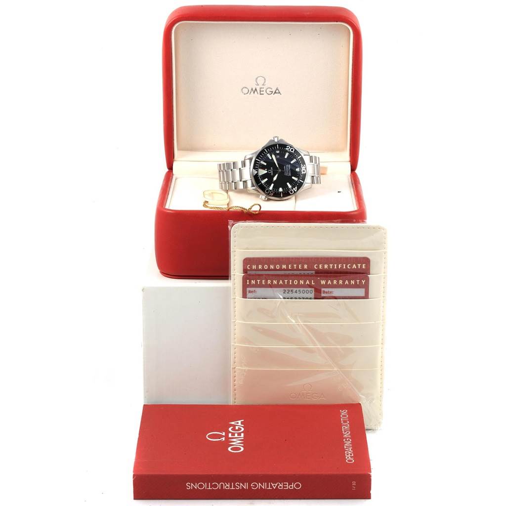 The image shows an Omega Seamaster 2254.50.00 Men
s Stainless Steel Black Dial 2254.50.00 Men
s Stainless Steel Black Dial watch in an open red box, accompanied by warranty cards and an operating instructions booklet.