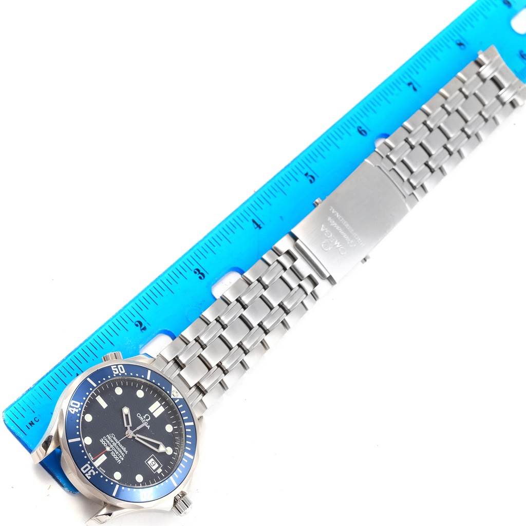 The image shows an Omega Seamaster 2531.80.00 Men
s Stainless Steel Blue Dial 2531.80.00 Men
s Stainless Steel Blue Dial watch laid flat next to a ruler, displaying the face, bracelet, and clasp.