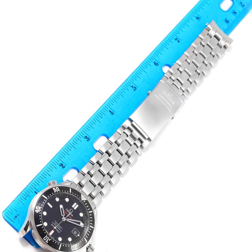 The image shows an Omega Seamaster 212.30.41.20.01.002 Men
s Stainless Steel Black Dial 212.30.41.20.01.002 Men
s Stainless Steel Black Dial watch laid flat, with the face, bracelet, and clasp visible next to a blue ruler for scale.