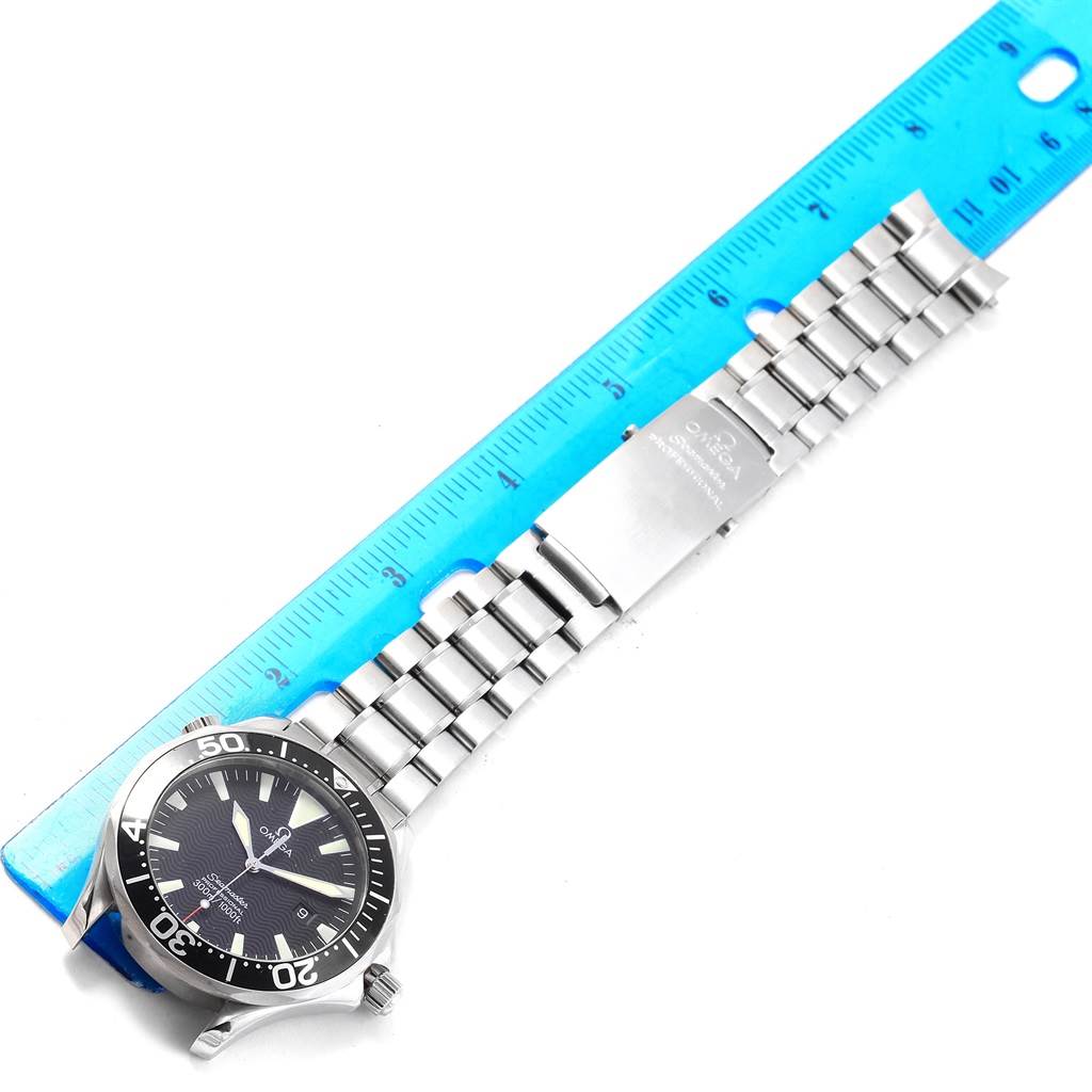 The image shows an Omega Seamaster 2264.50.00 Men
s Stainless Steel Black Dial 2264.50.00 Men
s Stainless Steel Black Dial watch laid flat with its bracelet extended, accompanied by a ruler for scale.