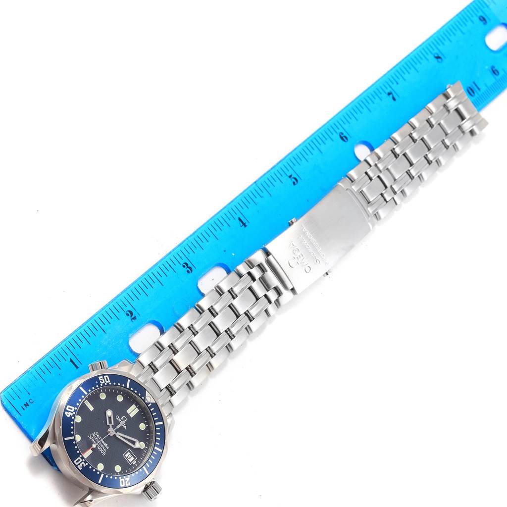 This is an overhead view of an Omega Seamaster 2561.80.00 Men
s Stainless Steel Blue Dial 2561.80.00 Men
s Stainless Steel Blue Dial watch showing the face, bracelet, and clasp, alongside a ruler for size reference.