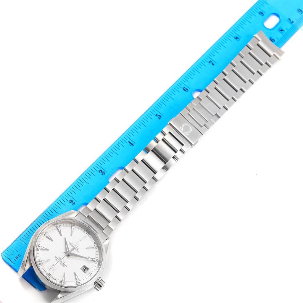 The image shows an Omega Aqua Terra 231.10.42.21.02.001 Men
s Stainless Steel Silver Dial 231.10.42.21.02.001 Men
s Stainless Steel Silver Dial watch laid flat next to a blue ruler, displaying the face, bezel, and stainless steel bracelet.