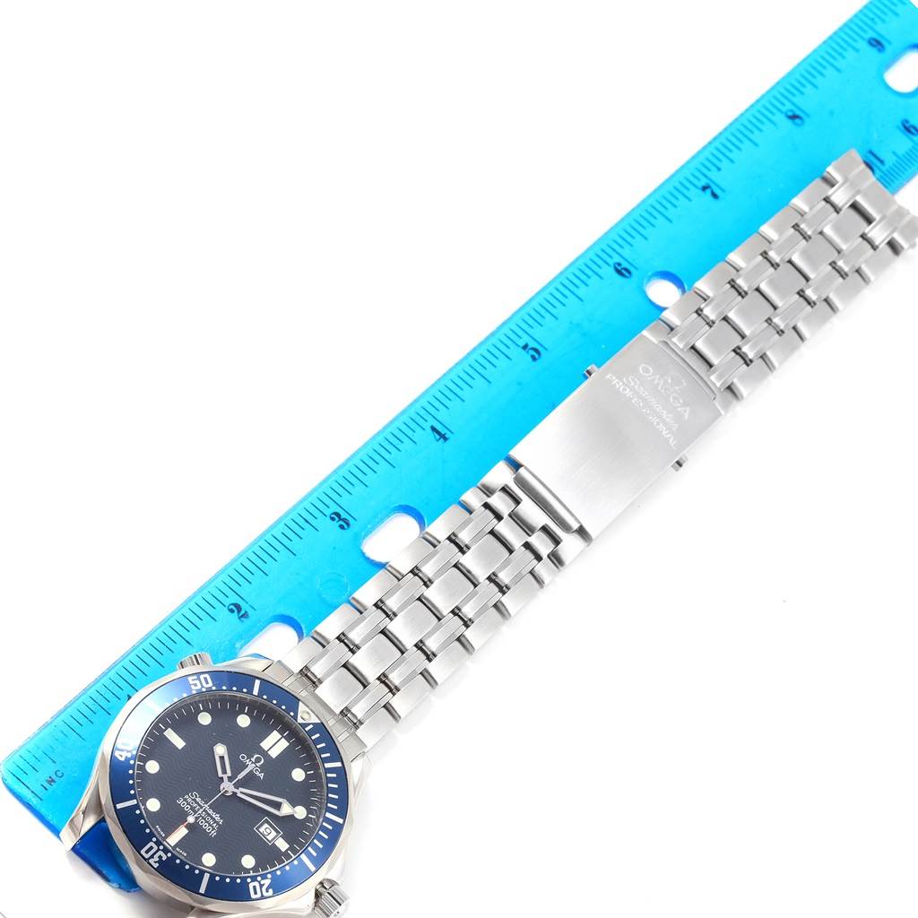 The image shows an Omega Seamaster 2541.80.00 Men
s Stainless Steel Blue Dial 2541.80.00 Men
s Stainless Steel Blue Dial watch laid flat alongside a blue ruler, displaying the watch head and the metal bracelet.