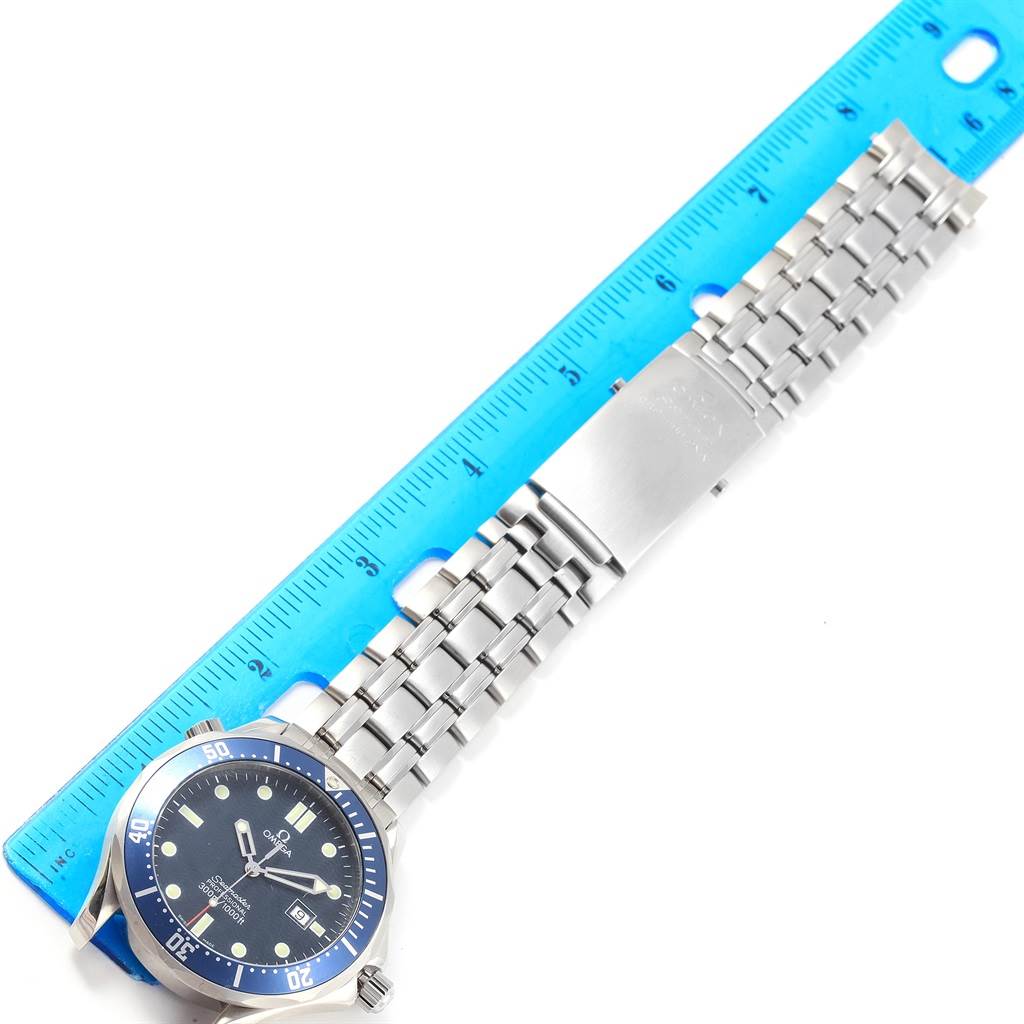 The image shows an Omega Seamaster 2541.80.00 Men
s Stainless Steel Blue Dial 2541.80.00 Men
s Stainless Steel Blue Dial watch laid flat next to a ruler, displaying the full face and metal bracelet.