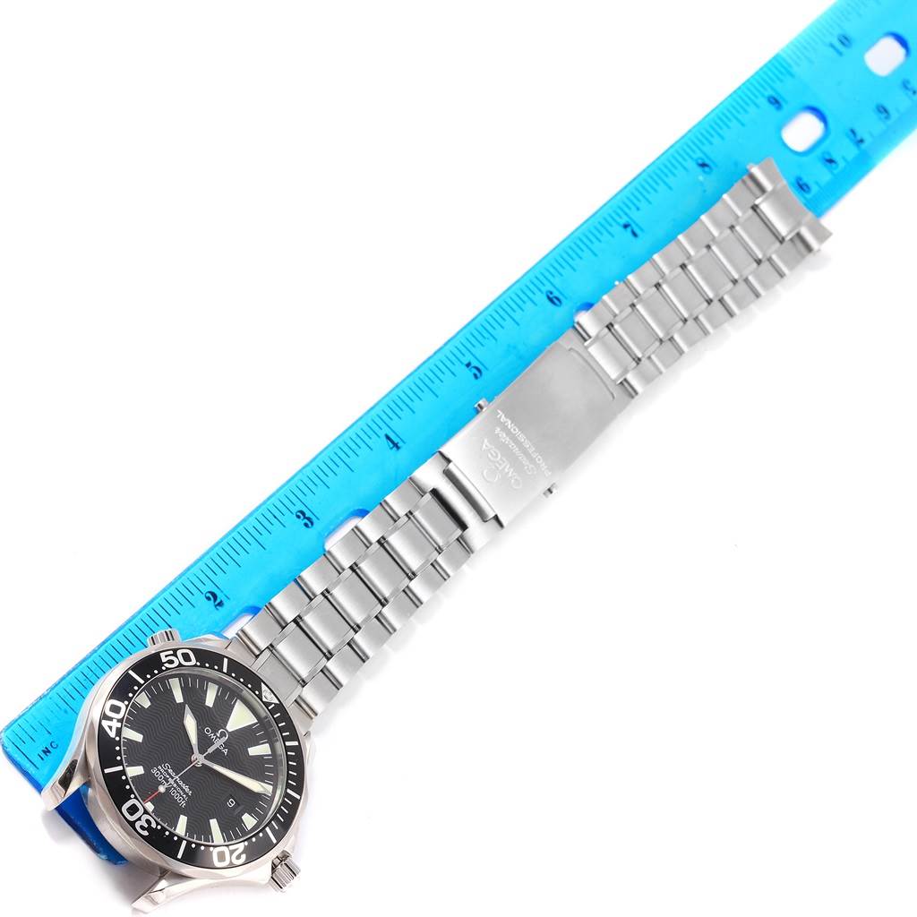 The image shows an Omega Seamaster 2264.50.00 Men
s Stainless Steel Black Dial 2264.50.00 Men
s Stainless Steel Black Dial watch laid flat with its full bracelet stretched alongside a blue ruler for measurement.