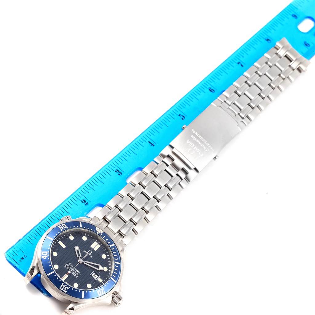 The Omega Seamaster 2541.80.00 Men
s Stainless Steel Blue Dial 2541.80.00 Men
s Stainless Steel Blue Dial watch is shown from a top-down angle, displaying the face, bezel, and metal bracelet alongside a ruler for scale.