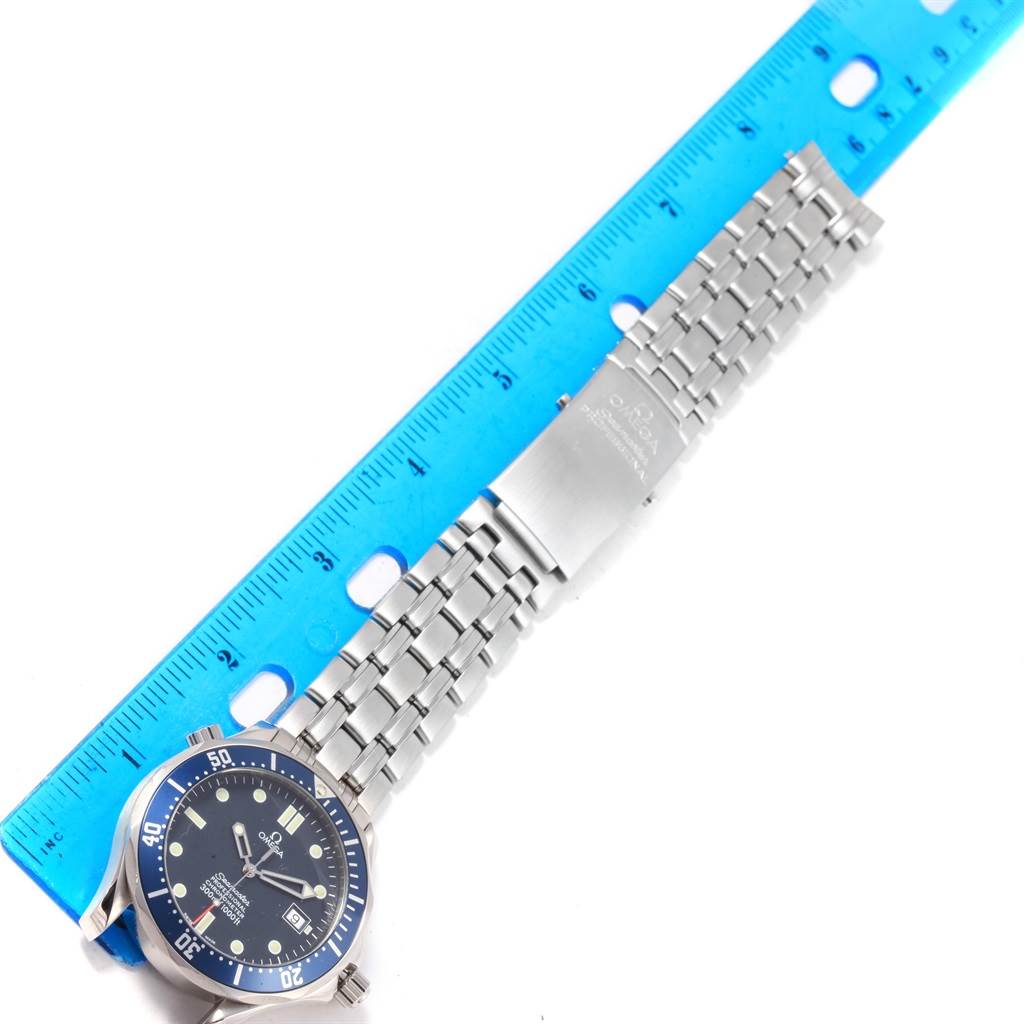 The image shows an Omega Seamaster 2531.80.00 Men
s Stainless Steel Blue Dial 2531.80.00 Men
s Stainless Steel Blue Dial watch from a top view, featuring the watch face, bezel, and metal bracelet alongside a blue ruler for scale.