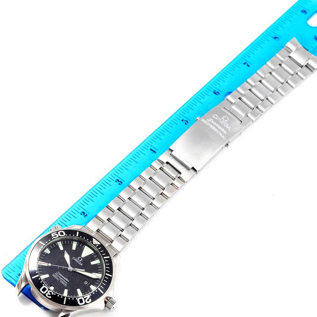 The image shows an Omega Seamaster 2264.50.00 Men
s Stainless Steel Black Dial 2264.50.00 Men
s Stainless Steel Black Dial watch laid flat with its stainless steel bracelet next to a blue ruler for measurement.