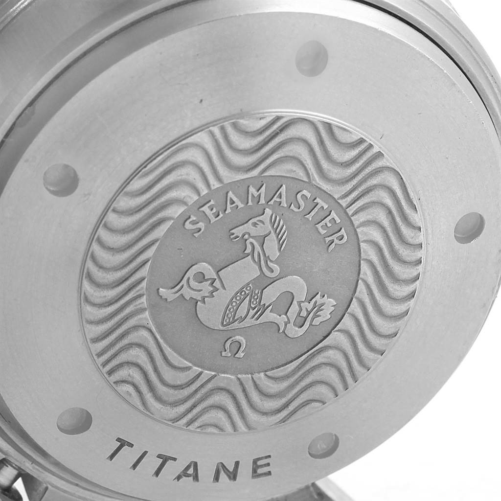 The image shows a close-up of the back case of an Omega Seamaster 2298.80.00 Men
s Titanium Blue Dial 2298.80.00 Men
s Titanium Blue Dial watch with engraving details and the word "Titane."