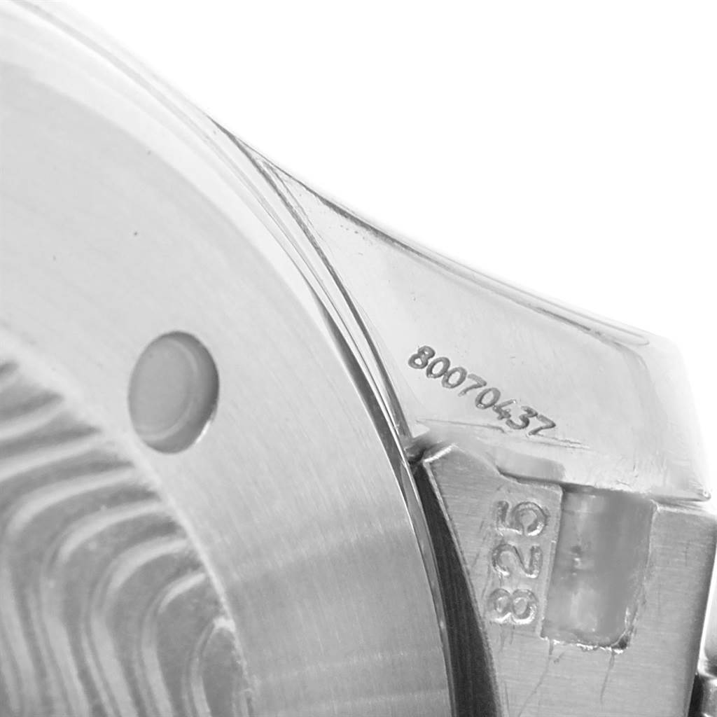 The image shows a close-up of a Seamaster model by Omega, focusing on the edge of the case and the serial number.