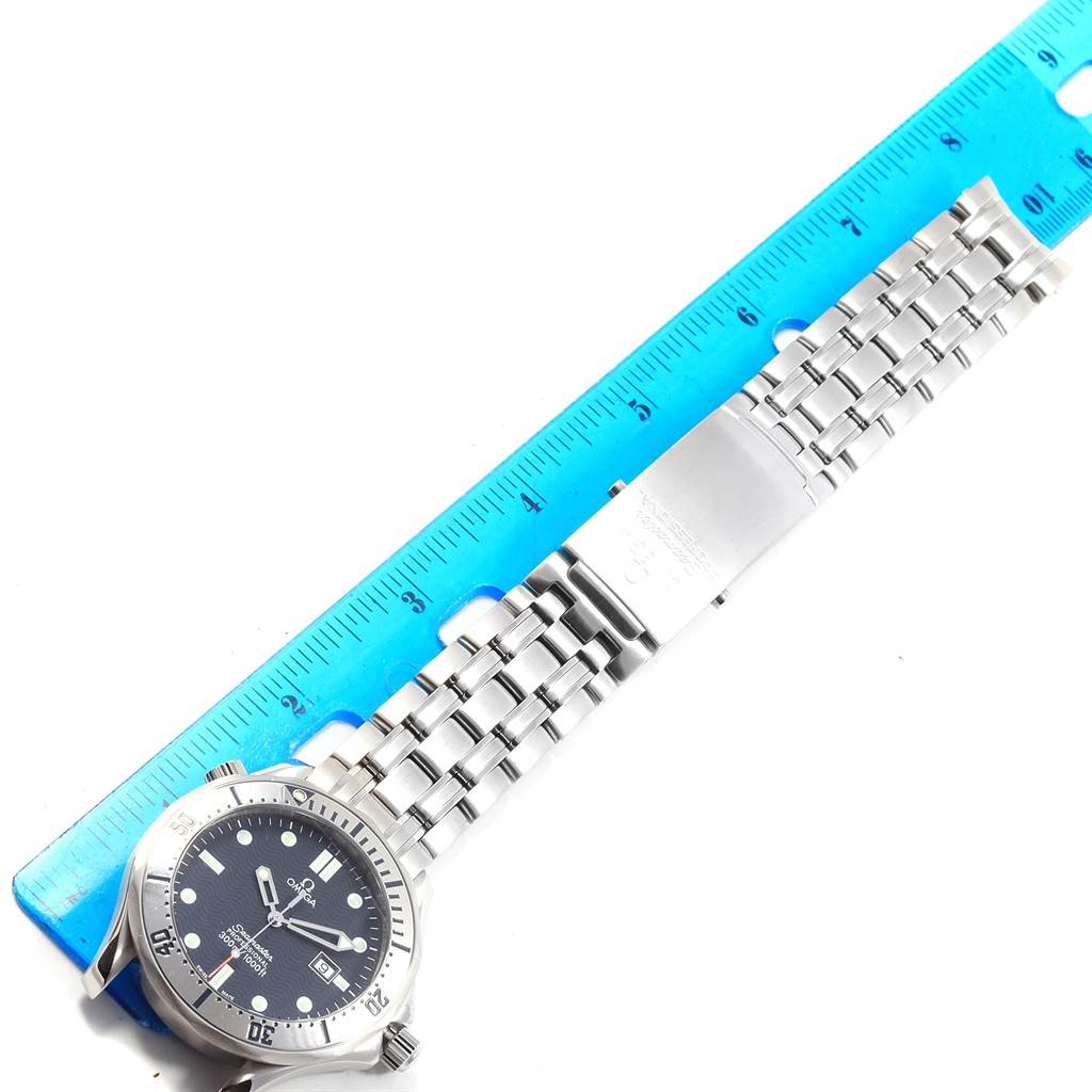 The image shows an Omega Seamaster 2542.80.00 Men
s Stainless Steel Blue Dial 2542.80.00 Men
s Stainless Steel Blue Dial watch from a top-down angle, displaying the face, bezel, and bracelet alongside a ruler.