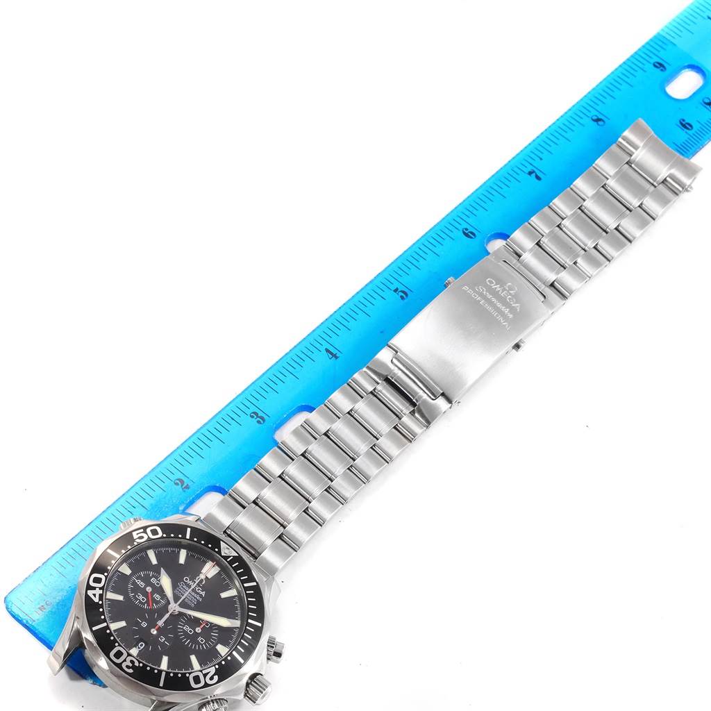 The image shows an Omega Seamaster 2594.52.00 Men
s Stainless Steel Black Dial 2594.52.00 Men
s Stainless Steel Black Dial watch laid flat next to a ruler, including the face, bezel, and bracelet.