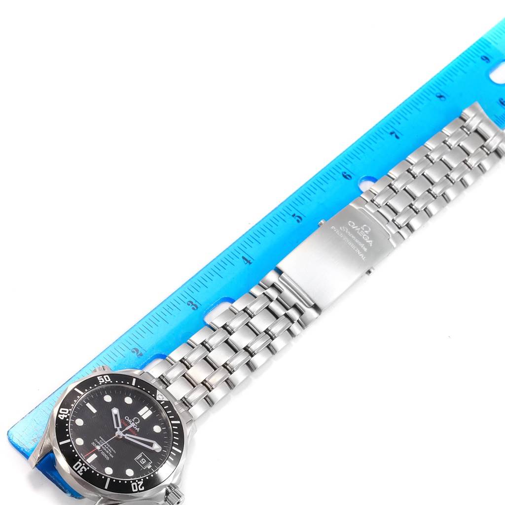 The Omega Seamaster 212.30.41.20.01.002 Men
s Stainless Steel Black Dial 212.30.41.20.01.002 Men
s Stainless Steel Black Dial watch is shown horizontally alongside a blue ruler, displaying its face and metal bracelet.