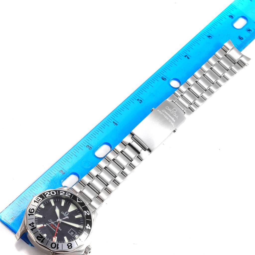 The image shows an Omega Seamaster 2536.50.00 Men's Stainless Steel Black Dial 2536.50.00 Men's Stainless Steel Black Dial watch laid flat with its face, stainless steel bracelet, and clasp visible, alongside a ruler for scale.