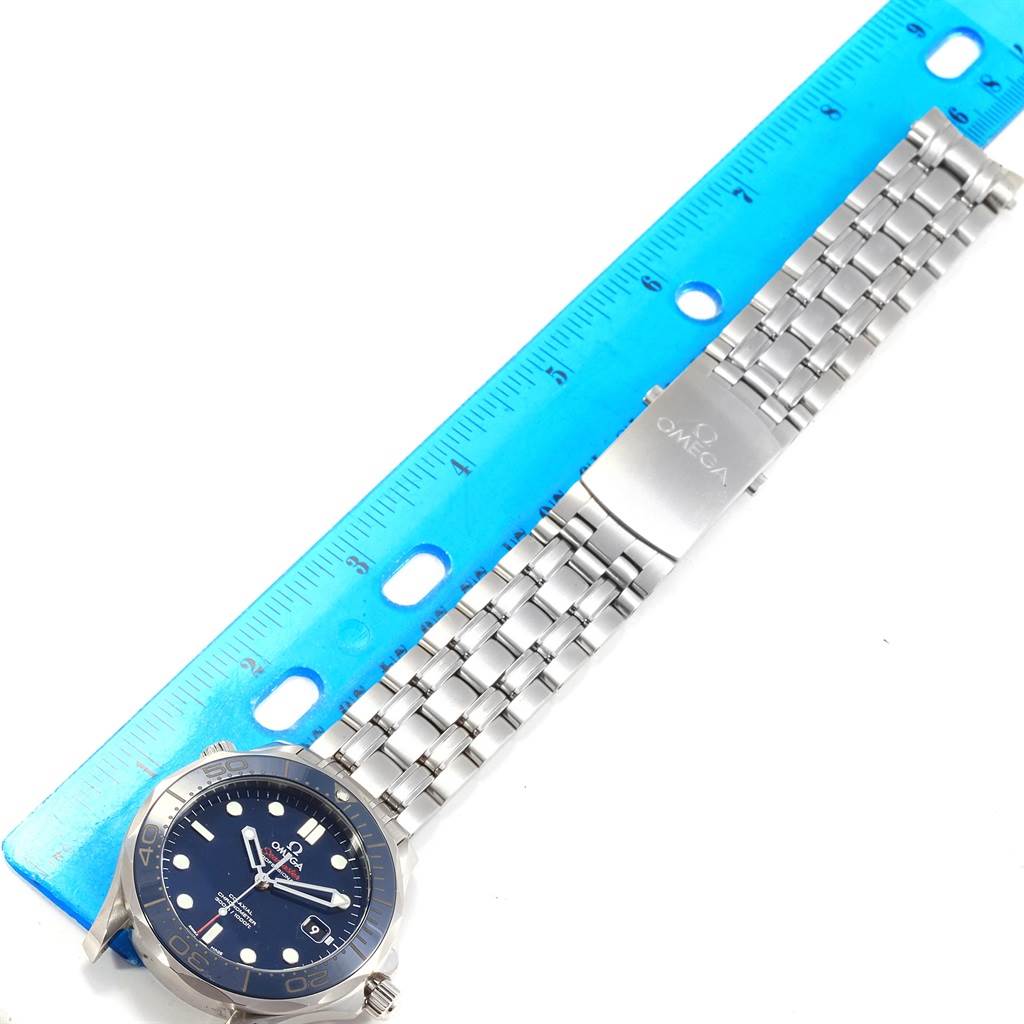 The Omega Seamaster 212.30.41.20.03.001 Men
s Stainless Steel Blue Dial 212.30.41.20.03.001 Men
s Stainless Steel Blue Dial watch is shown from a top view, displaying the face, bezel, and metal bracelet alongside a blue ruler.