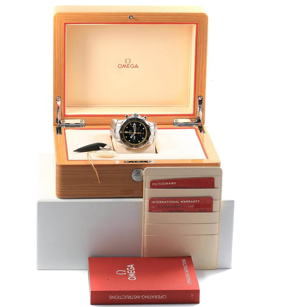 The image shows an Omega Seamaster 212.30.44.50.01.002 Men
s Stainless Steel Black Dial 212.30.44.50.01.002 Men
s Stainless Steel Black Dial watch in its open wooden box, along with the warranty cardholder and operating instructions booklet.