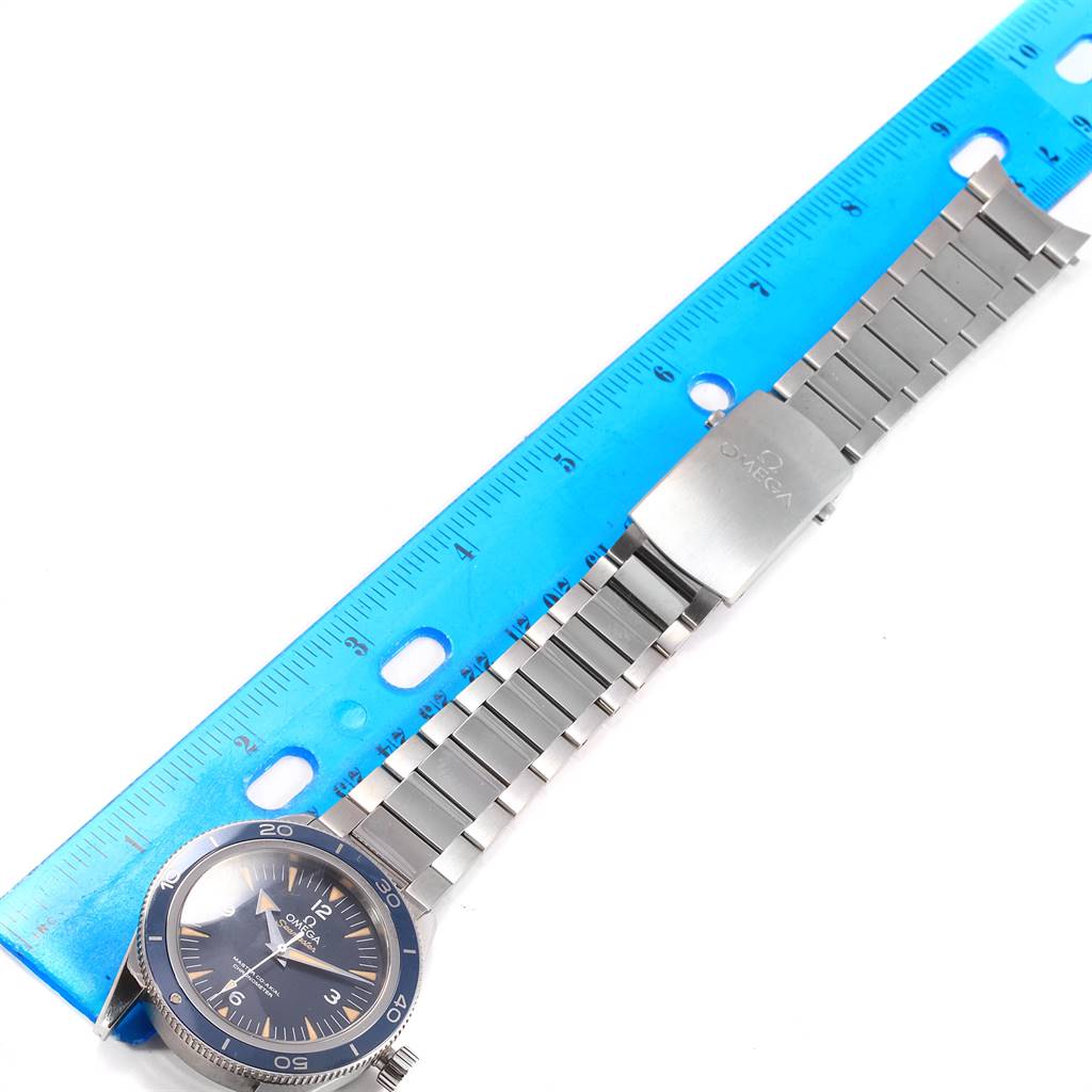 The image shows the Omega Seamaster 233.90.41.21.03.001 Men
s Titanium Blue Dial 233.90.41.21.03.001 Men
s Titanium Blue Dial watch laid flat from an overhead angle, with a blue ruler next to it.