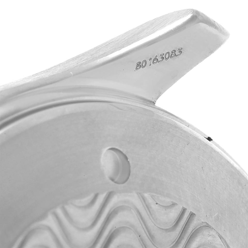 This close-up image shows a part of the casing or bezel of an Omega Seamaster 2254.50.00 Men
s Stainless Steel Black Dial 2254.50.00 Men
s Stainless Steel Black Dial watch, highlighting its serial number and intricate design.