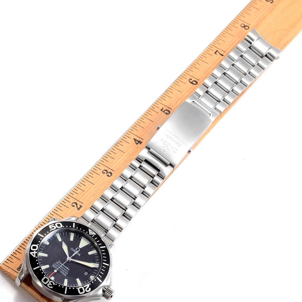 The image shows the Omega Seamaster 2254.50.00 Men
s Stainless Steel Black Dial 2254.50.00 Men
s Stainless Steel Black Dial watch laid flat, measured against a ruler, displaying its face, bezel, and metal bracelet.