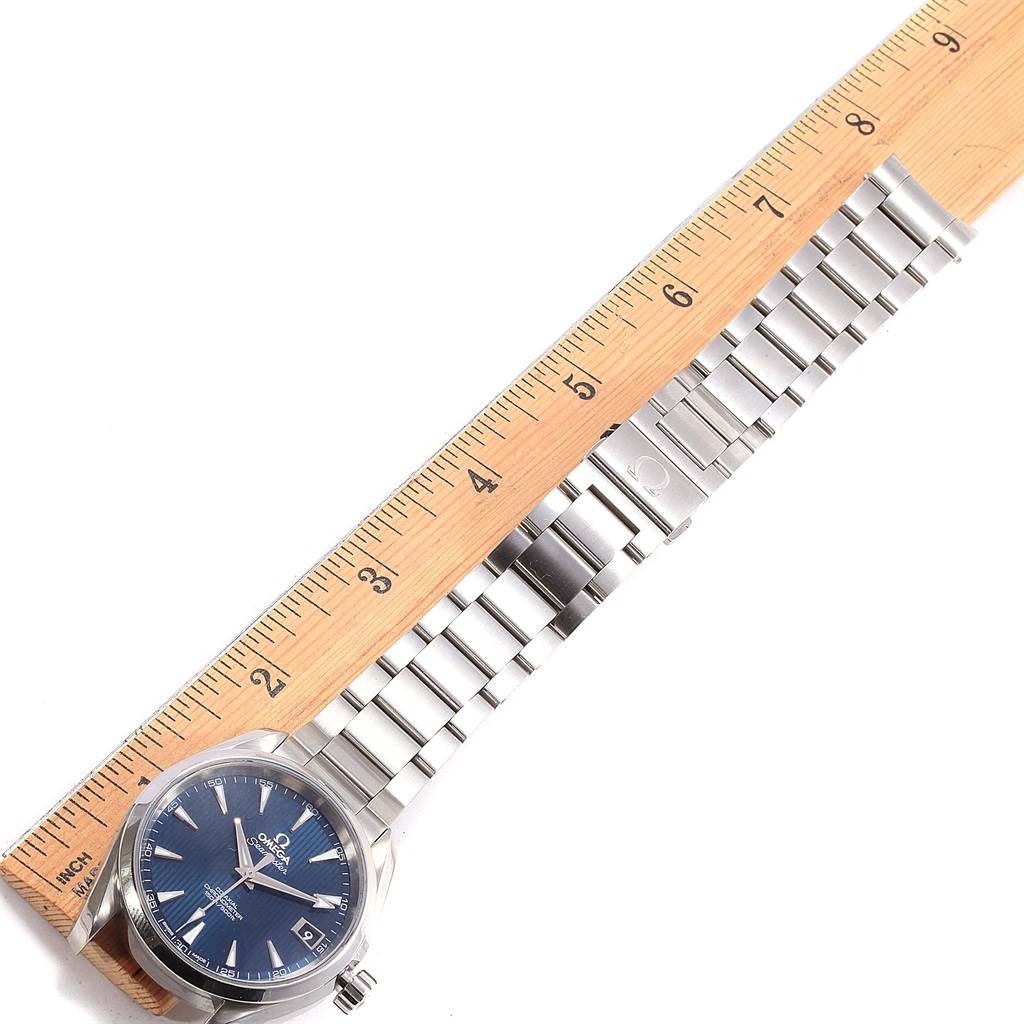 The Omega Seamaster 231.10.39.21.03.002 Men's Stainless Steel Blue Dial 231.10.39.21.03.002 Men's Stainless Steel Blue Dial watch is shown face-up, along with its metal bracelet, positioned next to a ruler for scale.