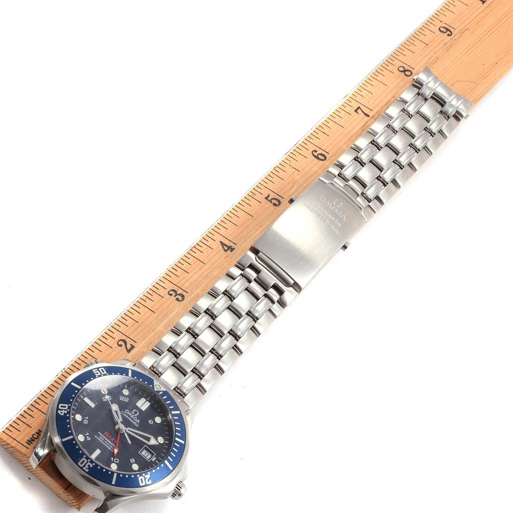 The image shows an Omega Seamaster 2535.80.00 Men's Stainless Steel Blue Dial 2535.80.00 Men's Stainless Steel Blue Dial watch laid flat, highlighting the face, bezel, and metal bracelet, with a ruler beside for scale.