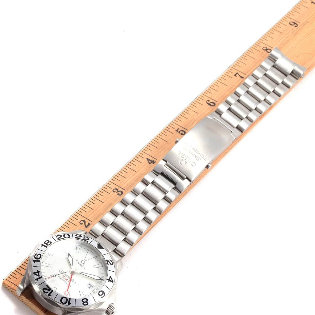 The image shows an Omega Seamaster 2538.20.00 Men
s Stainless Steel White Dial 2538.20.00 Men
s Stainless Steel White Dial watch laid flat next to a ruler, highlighting its face and metal bracelet.