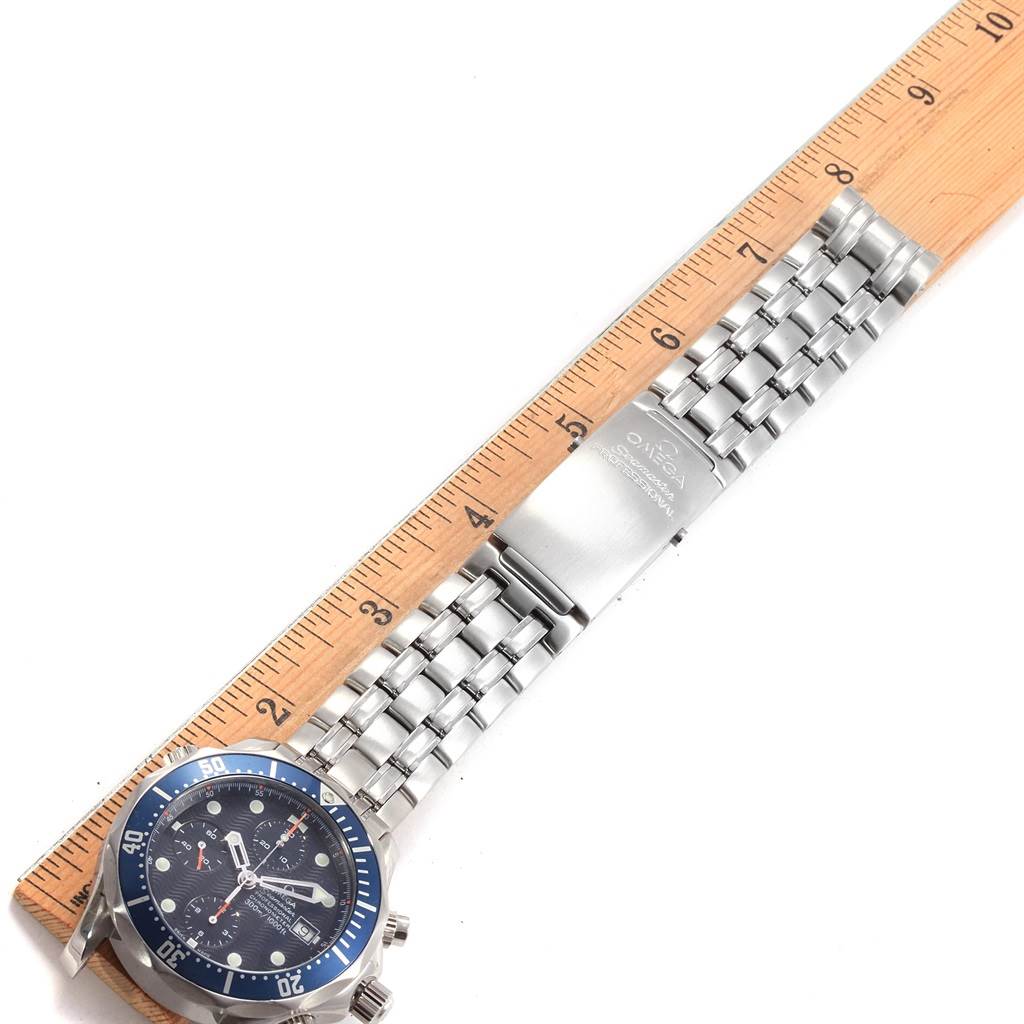 The Omega Seamaster 2599.80.00 Men
s Stainless Steel Blue Dial 2599.80.00 Men
s Stainless Steel Blue Dial watch is shown flat from an overhead angle, displaying the face, stainless steel bracelet, and clasp, with a ruler for scale.