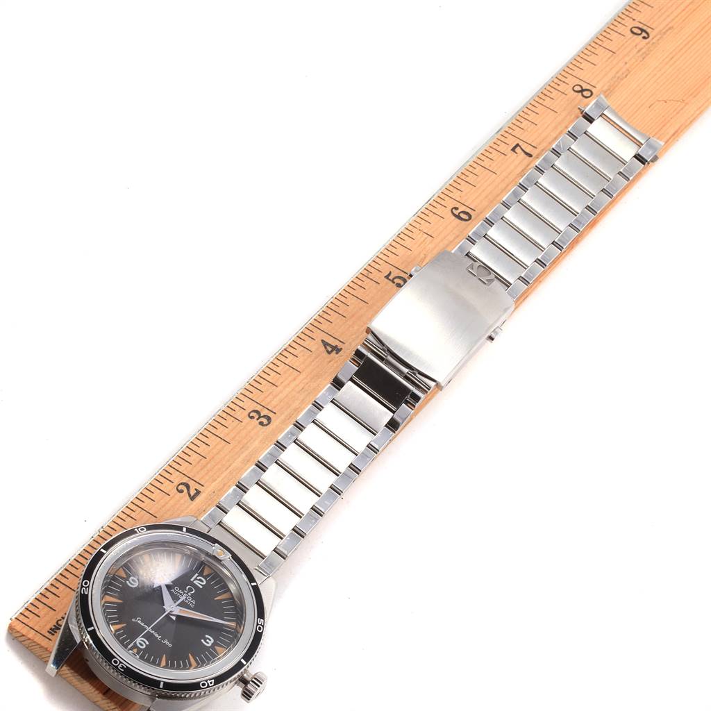 The image shows the front view of an Omega Seamaster 234.10.39.20.01.001 Men's Stainless Steel Black Dial 234.10.39.20.01.001 Men's Stainless Steel Black Dial watch with a metal bracelet laid next to a ruler.