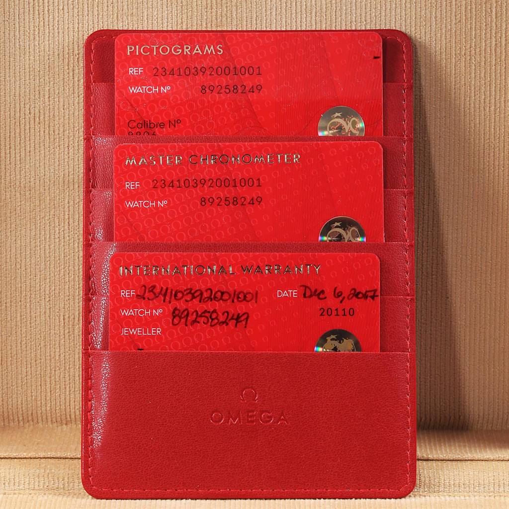 The image shows the warranty cards and documentation for the Omega Seamaster 234.10.39.20.01.001 Men's Stainless Steel Black Dial 234.10.39.20.01.001 Men's Stainless Steel Black Dial watch in a red Omega-branded cardholder.