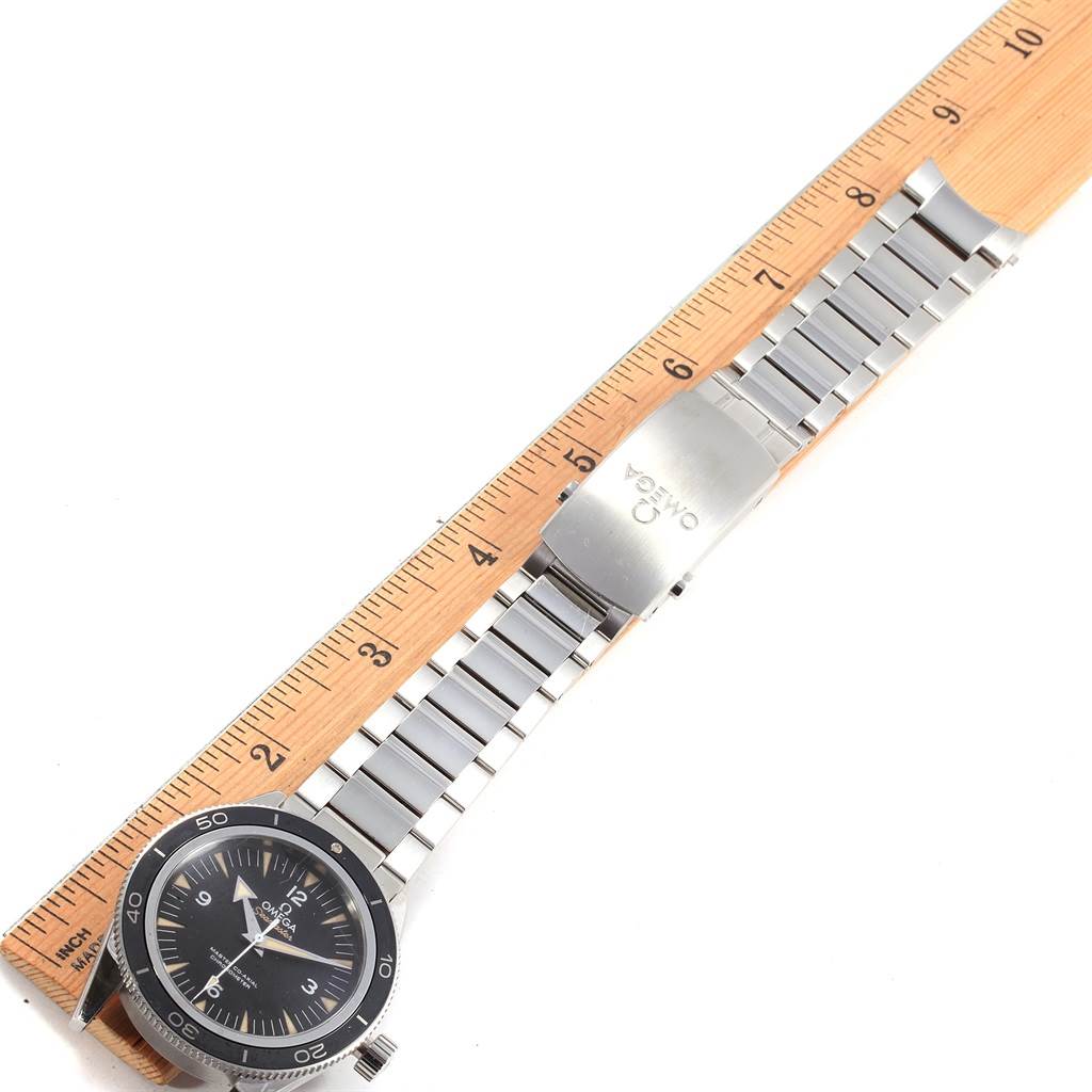 The Omega Seamaster 233.30.41.21.01.001 Men
s Stainless Steel Black Dial 233.30.41.21.01.001 Men
s Stainless Steel Black Dial watch is shown from a top-down angle displaying the watch face, bezel, and metal bracelet next to a ruler.