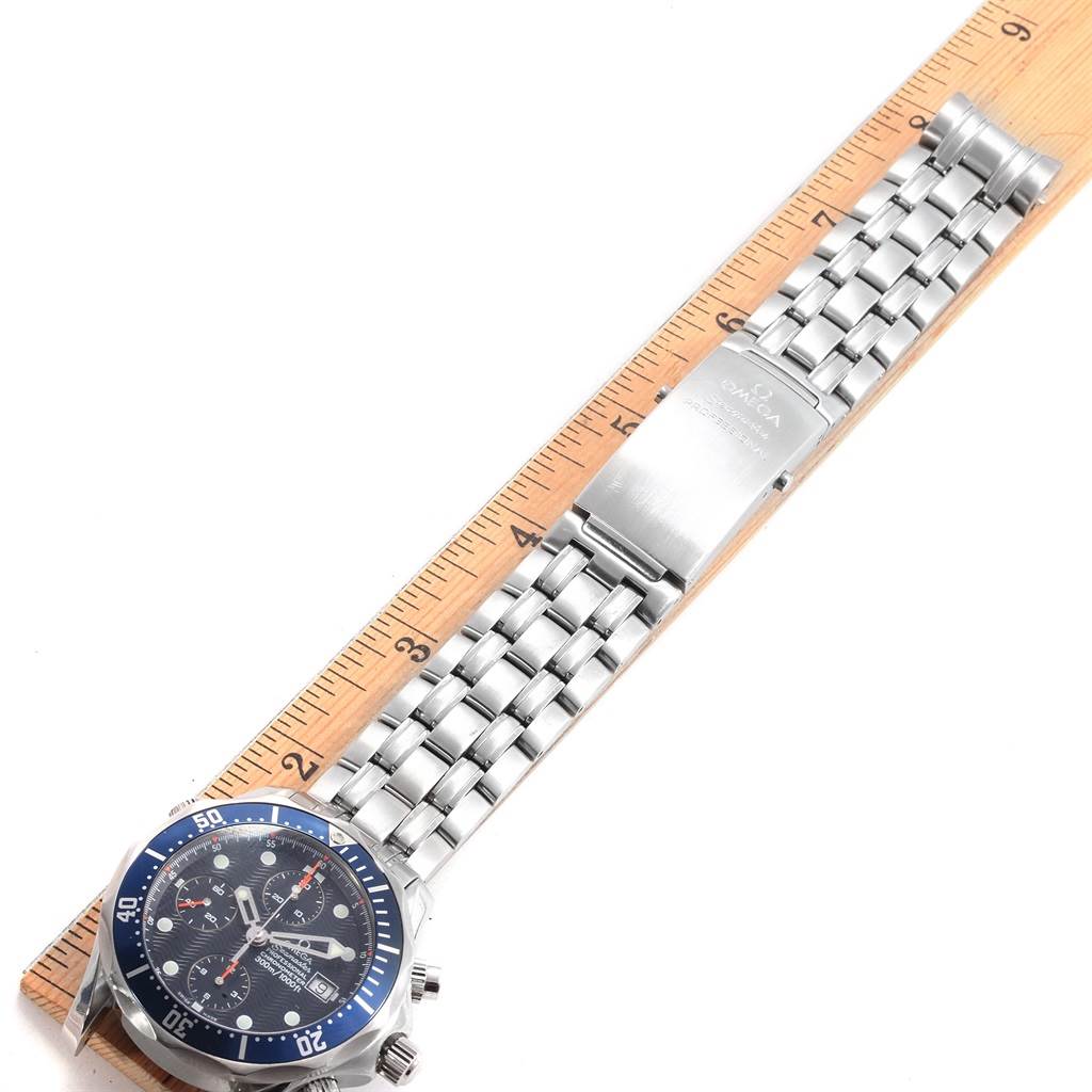 This image shows the Omega Seamaster 2599.80.00 Men
s Stainless Steel Blue Dial 2599.80.00 Men
s Stainless Steel Blue Dial watch horizontally, showcasing its face, bezel, bracelet, and clasp alongside a ruler.