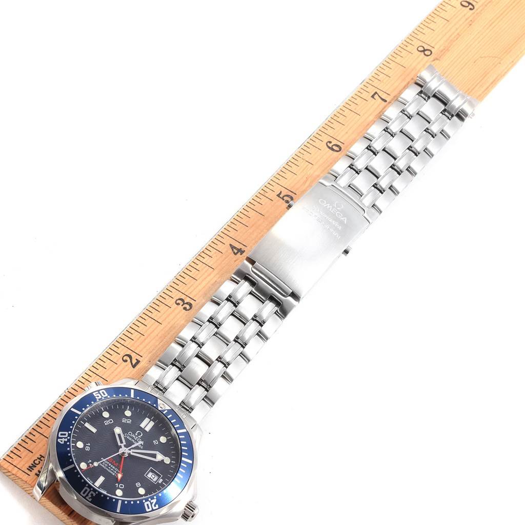 The image shows a top-down view of the Omega Seamaster 2535.80.00 Men
s Stainless Steel Blue Dial 2535.80.00 Men
s Stainless Steel Blue Dial watch showcasing its face, bezel, bracelet, and clasp laid next to a ruler for scale.