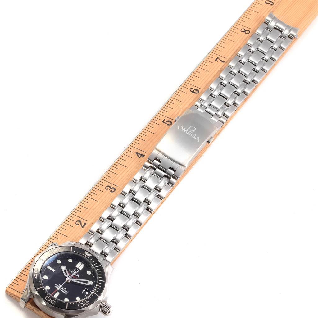 The image shows the Omega Seamaster 212.30.36.20.01.002 Men
s Stainless Steel Black Dial 212.30.36.20.01.002 Men
s Stainless Steel Black Dial watch laid flat with a ruler, displaying its face, bracelet, and clasp.