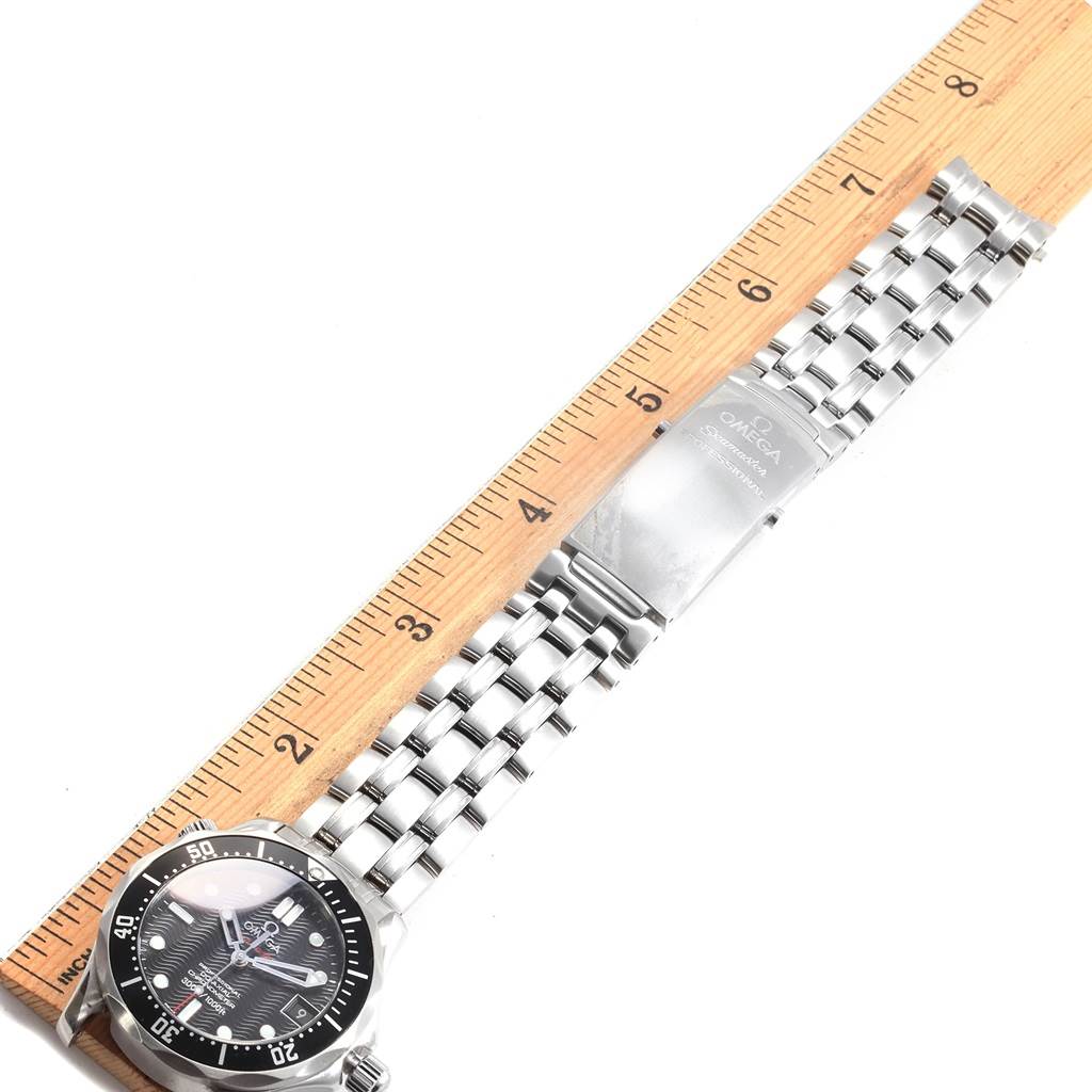 The image shows a top-down view of the Omega Seamaster 212.30.36.20.01.001 Men
s Stainless Steel Black Dial 212.30.36.20.01.001 Men
s Stainless Steel Black Dial watch, focusing on the dial and metal strap against a ruler for scale.